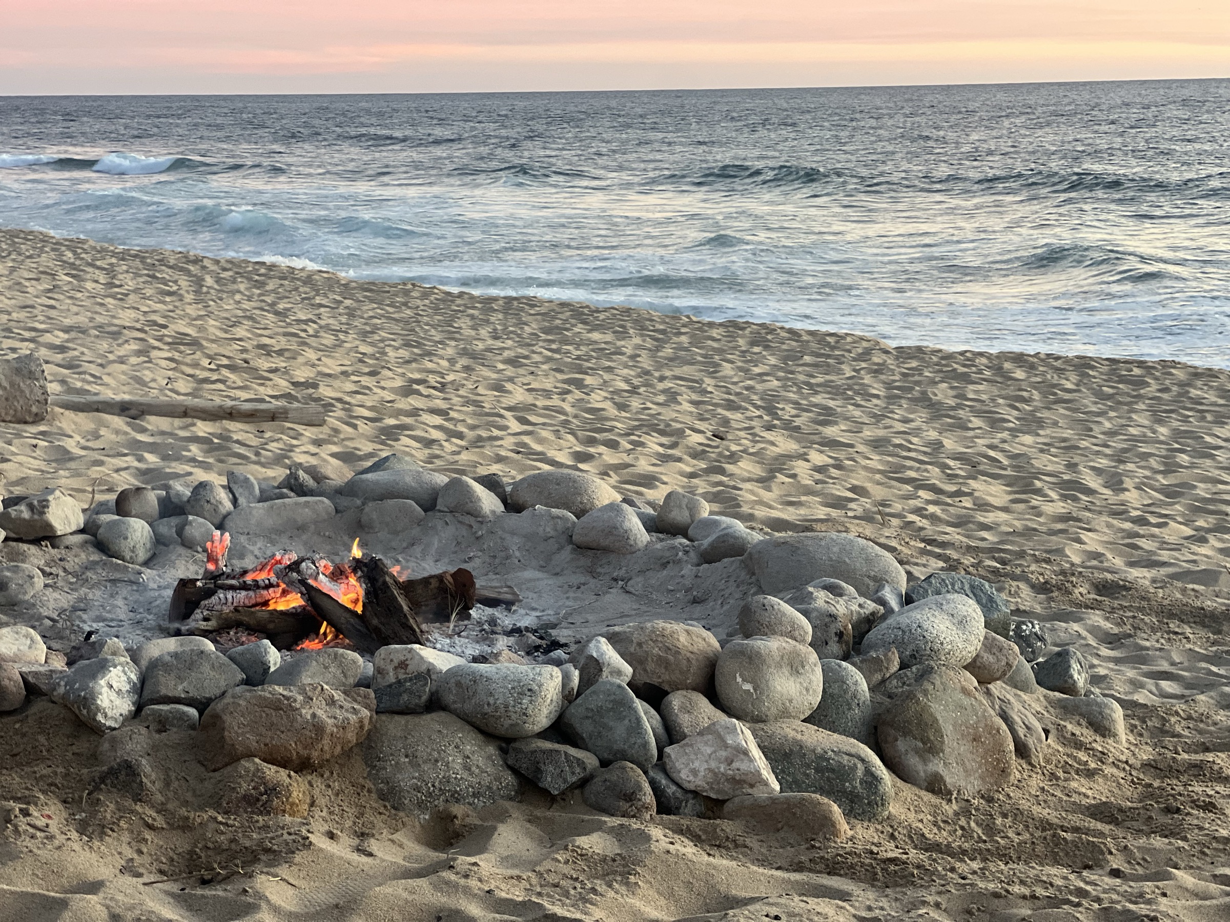 Campfire on the beach at dusk, Baja California Sur
